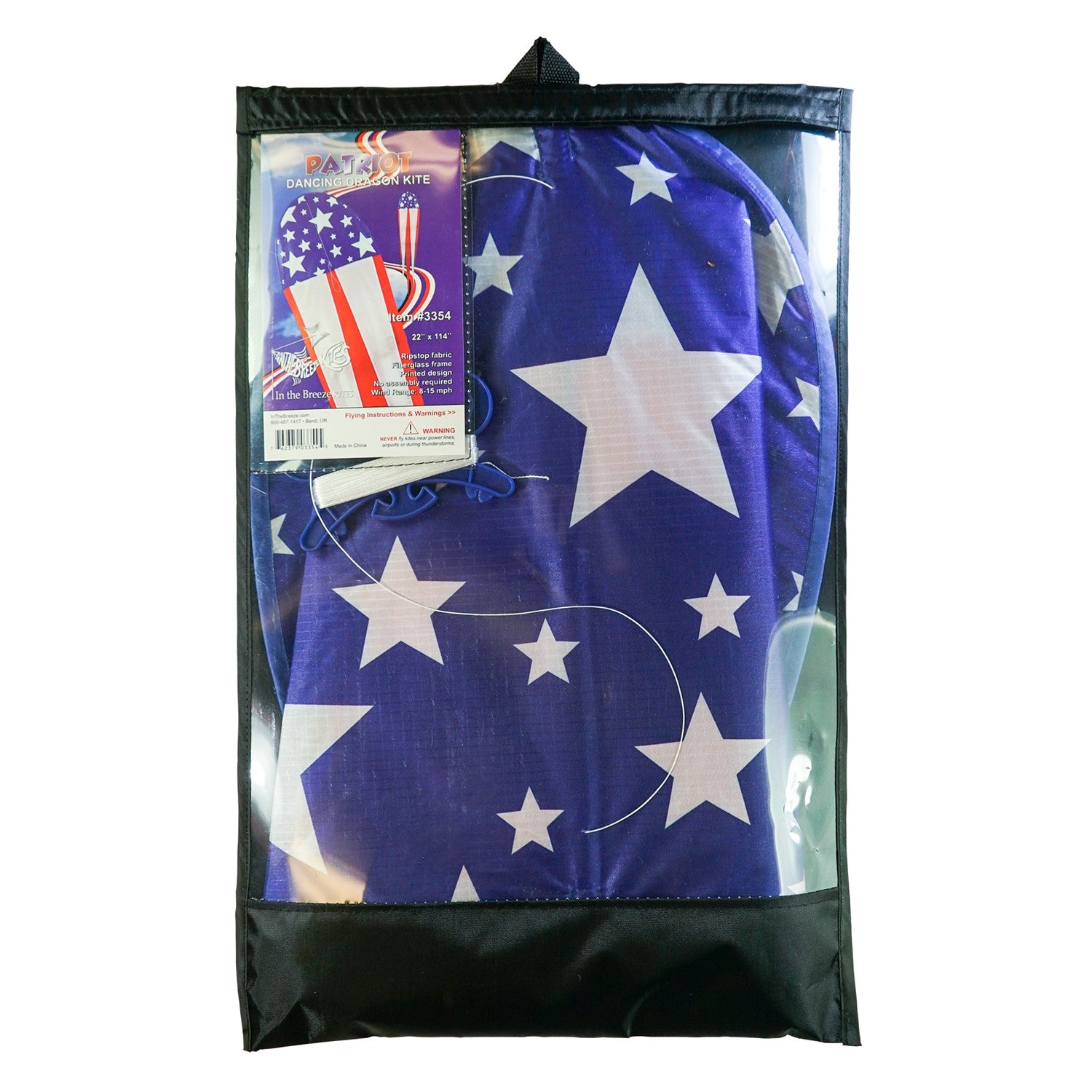 22" Patriot Dancing Dragon Kite with stars and stripes design soaring through the sky during a sunny outdoor event with tails flowing.