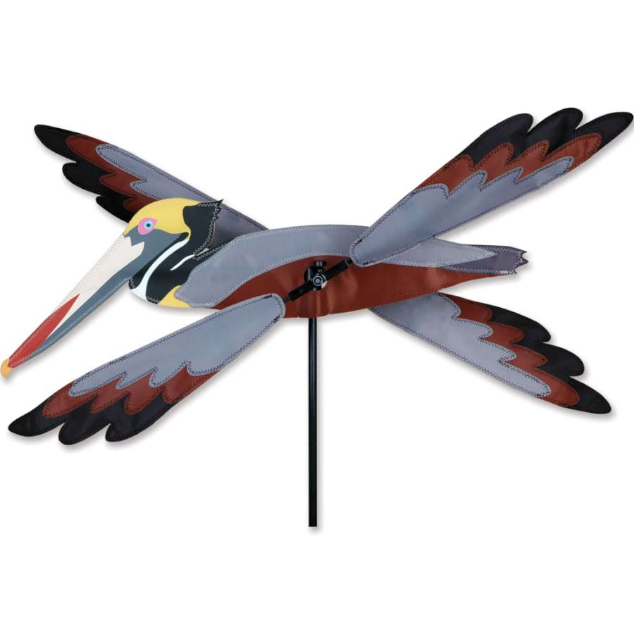 23 inch WhirliGig Spinner with a playful Brown Pelican design, made of SunTex fabric, gracefully spinning in a garden setting.