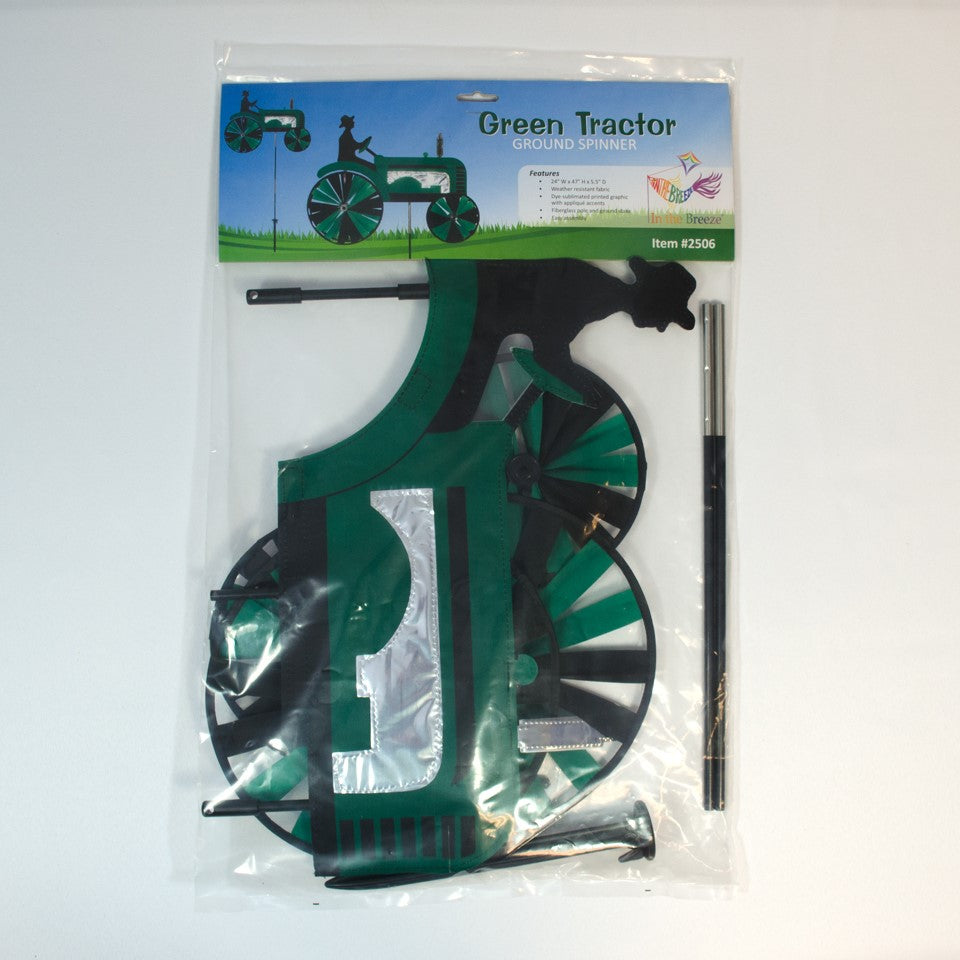 24-inch Green Tractor Spinner with four spinning wheels, vibrant design, and fiberglass frame displayed in a sunny garden setting.