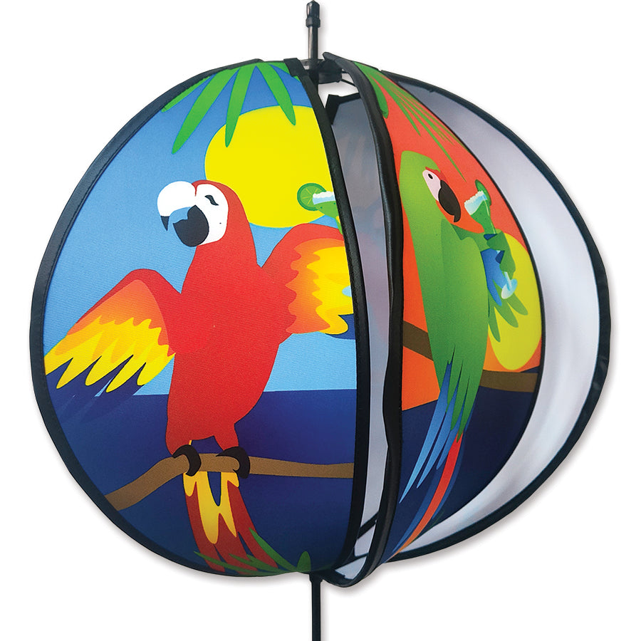 24 in. Ball Spinner - 5 O'clock Somewhere featuring colorful panels with birds and tropical drinks, displayed with a ground stake in a sunny garden setting.