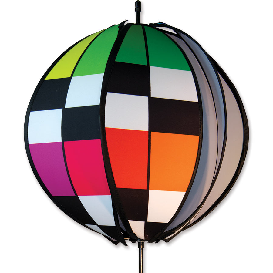 24 in. Ball Spinner - Rainbow Checkered featuring six colorful panels spinning in the breeze, set against a vibrant garden backdrop.