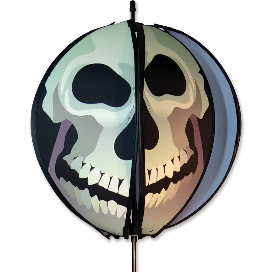 24 in. Ball Spinner - Skull featuring six bright panels displayed in a garden setting, rotating in the breeze.