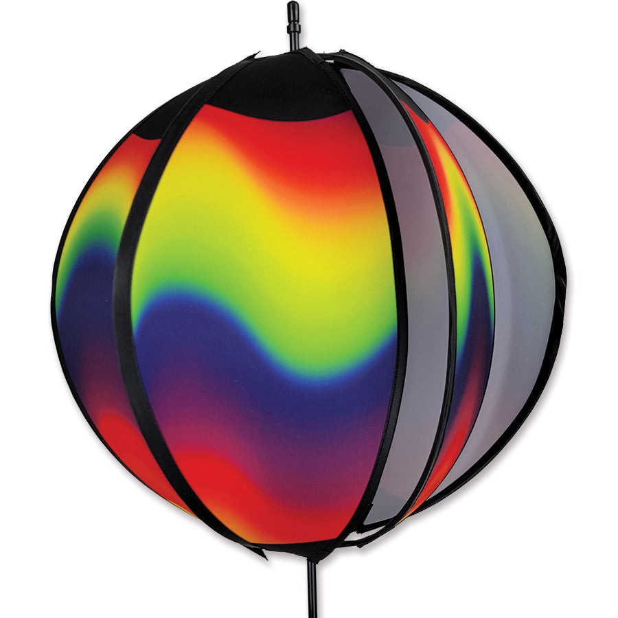 24 in. Ball Spinner with wavy gradient pattern prominently displayed in a garden, showcasing vibrant colors and motion.