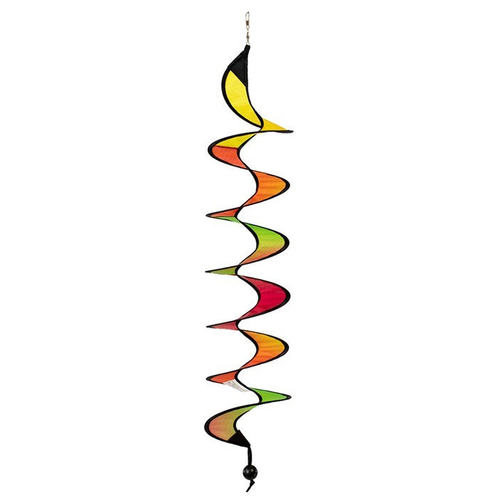 24-inch Jewel Curlie featuring a colorful rainbow graphic, hanging elegantly in an outdoor garden setting, moving gently in the breeze.