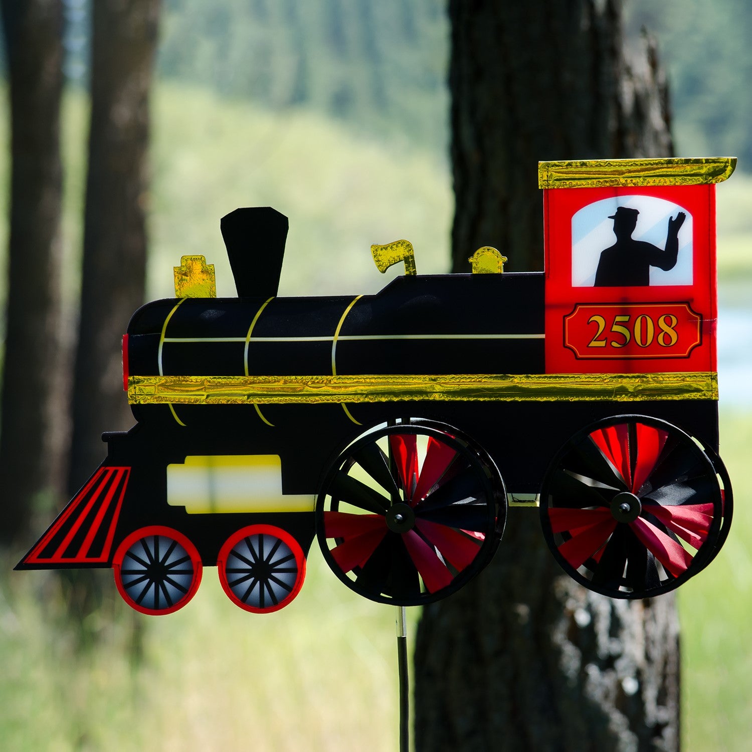 24-inch Steam Engine Spinner with vibrant colors and shiny applique accents, spinning gently in a garden setting, evoking retro train nostalgia.