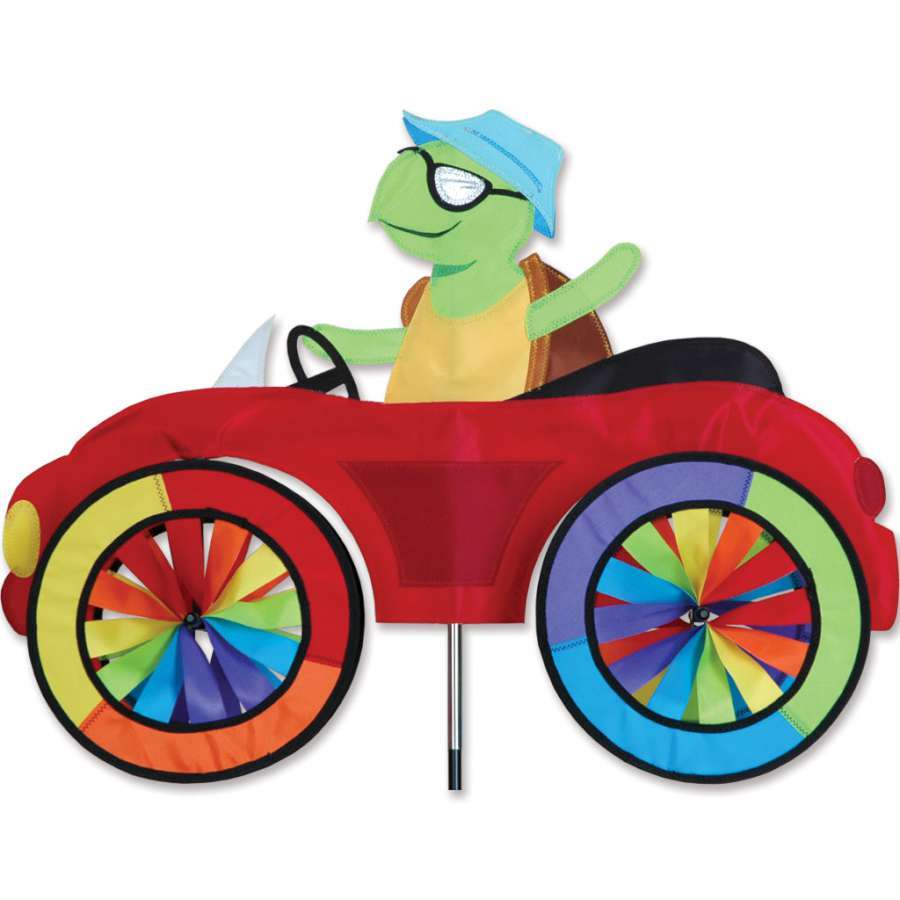 25 in. Car Spinner - Turtle displayed in a garden, showcasing vibrant colors and spinning wheels in an outdoor setting.