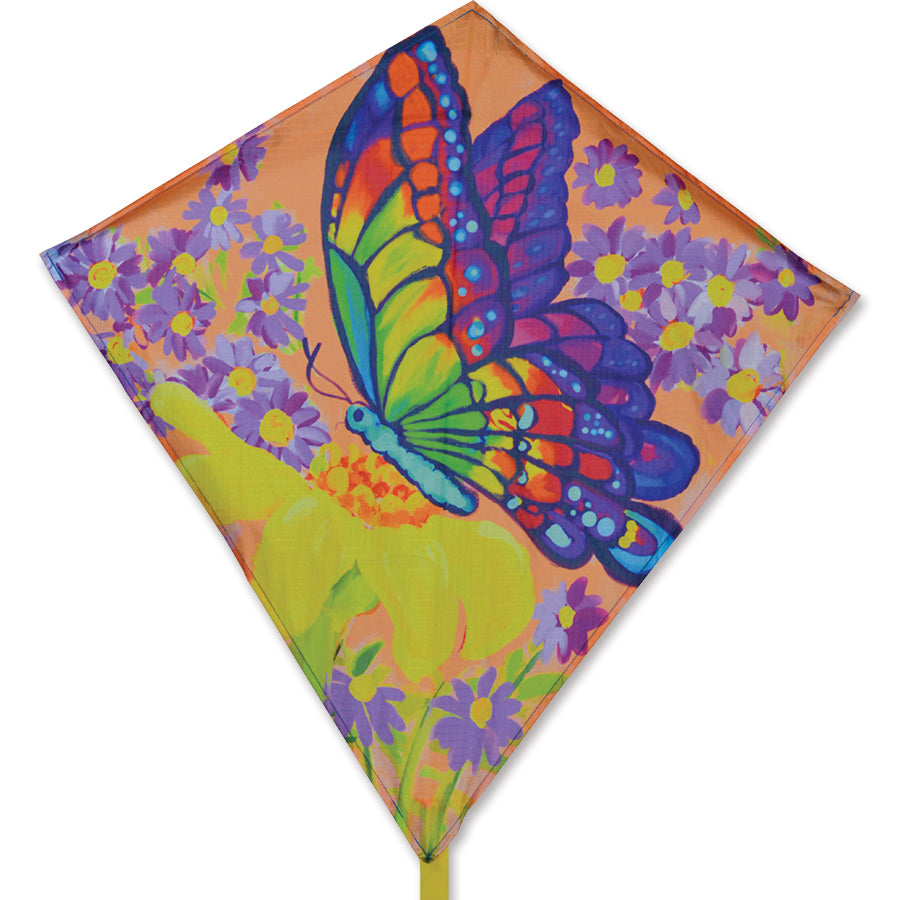 Vibrant 25 in. Diamond Kite featuring a butterfly and wildflowers design soaring in the sky on a sunny day.