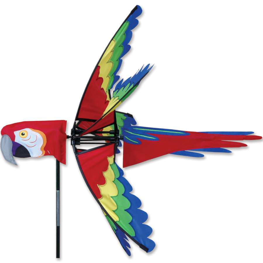 27 in. Scarlet Macaw Spinner hanging outdoors, featuring bright colors and a lively design that spins gracefully in the wind.