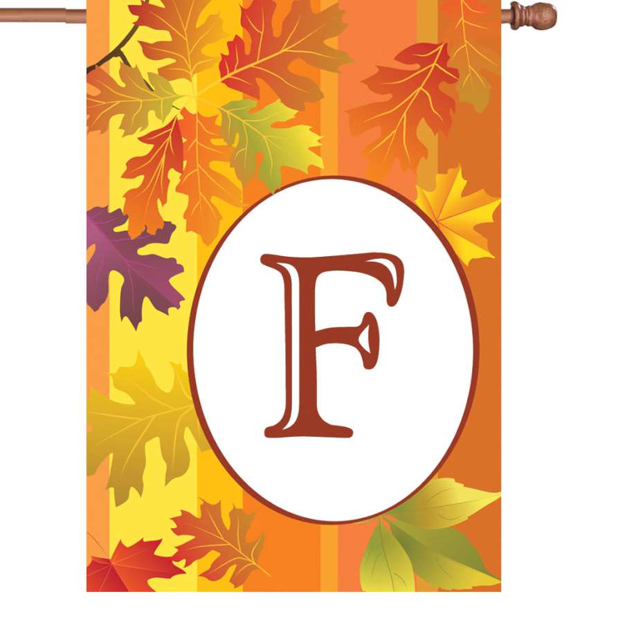 28 in. Fall Monogram Flag - F featuring an elegant letter 'F' designed in autumn colors, displayed on a flag stand in a front yard.