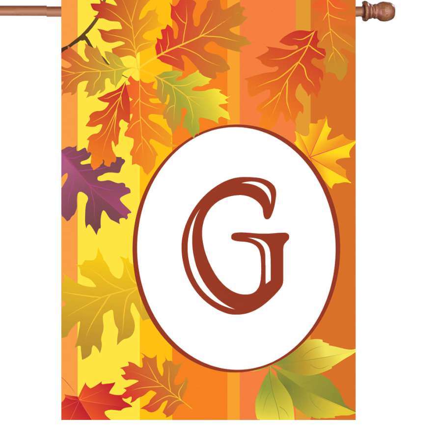 28-inch Fall Monogram Flag - G, featuring a vibrant autumn design displayed on a flagpole in a cozy outdoor setting.