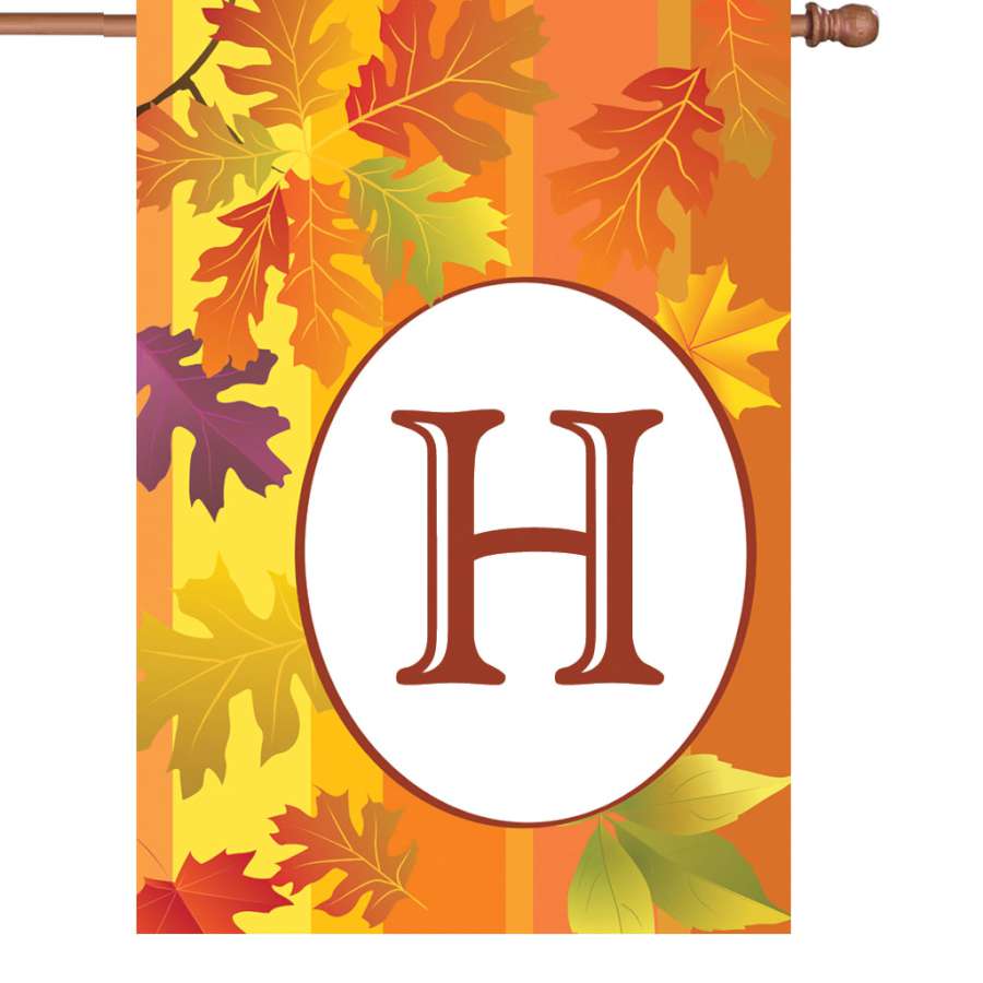 28 inch Fall Monogram Flag featuring the letter 'H' decorated with autumn leaves, displayed on a flag pole in a colorful garden setting.