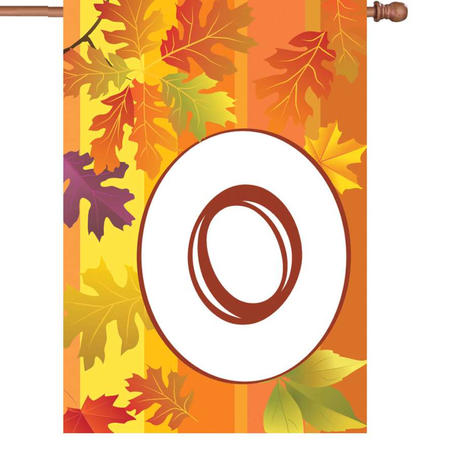 28 in. Fall Monogram Flag - O featuring a bold initial surrounded by autumn leaves, displayed in a front yard setting, capturing the essence of the season.