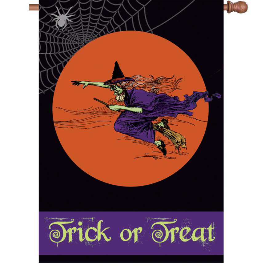 28 in. Flag - Flying Witch displays a colorful design of a witch flying on her broomstick, shown on a house flagpole in a fall setting.
