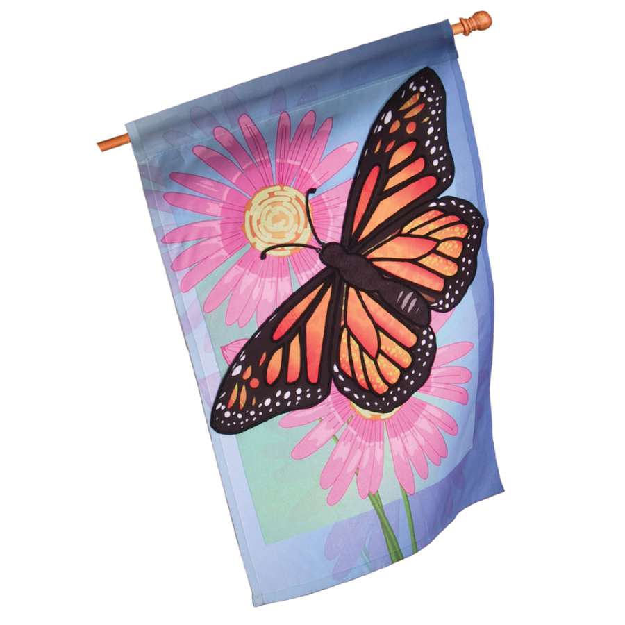 28 in. Flag - Merry Monarch featuring a colorful butterfly design, displayed on a garden flagpole in a vibrant outdoor setting.