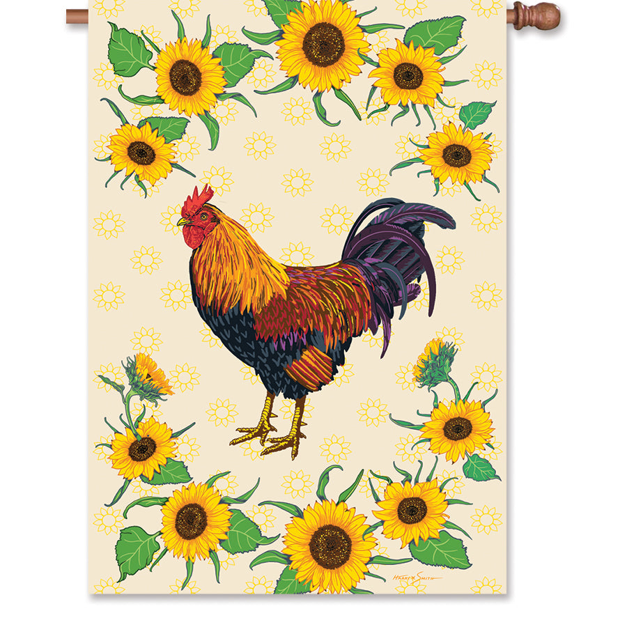 28 in. house flag featuring a sunflower and rooster design, illuminated for an eye-catching display in an outdoor garden setting.