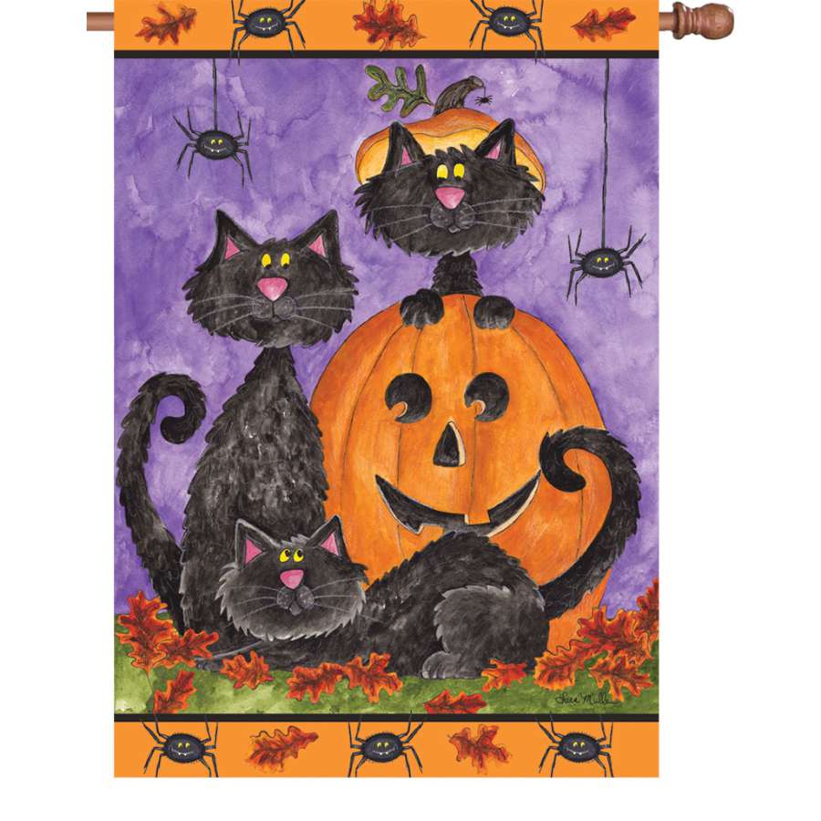 28 in. flag with a vibrant design of three playful black cats, illuminated and displayed outdoors, adding charm to a garden setting.