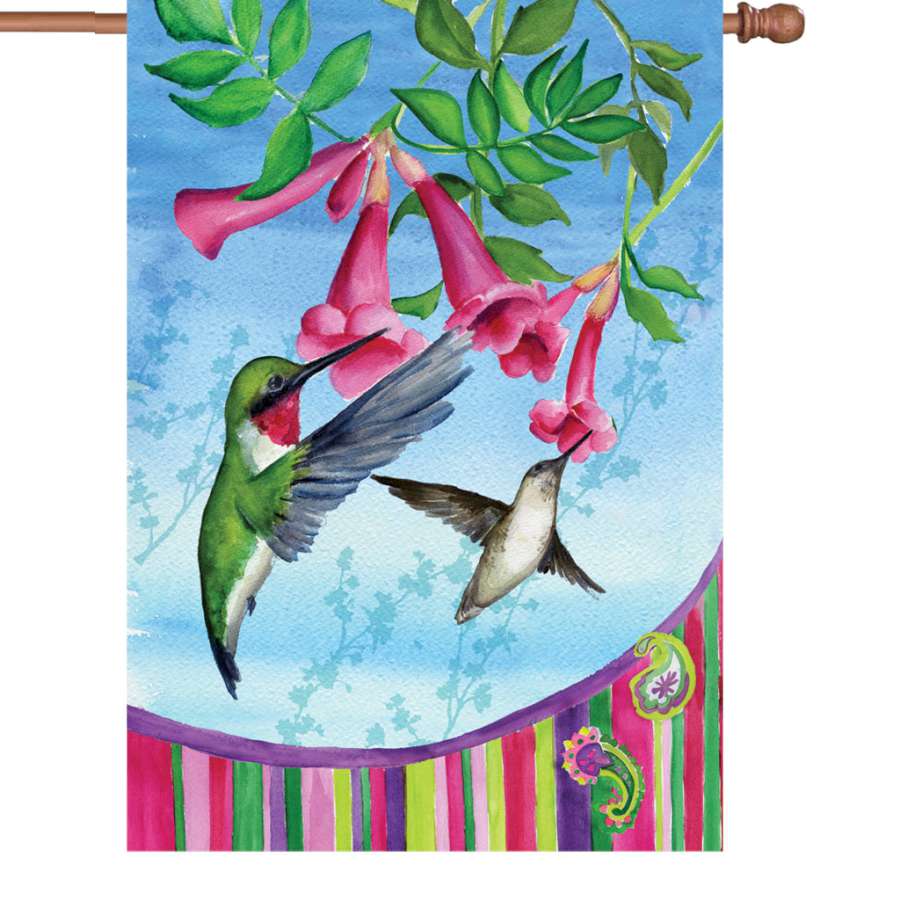 28 in. Hummingbirds Paisley flag featuring colorful hummingbirds and paisley patterns displayed in an outdoor garden setting.