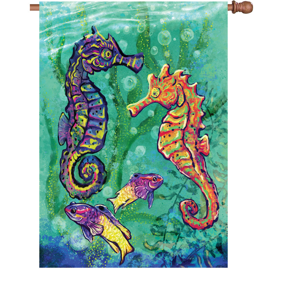 28 in. Seahorse flag made of fade-resistant fabric, featuring vibrant seahorse designs, displayed on a house flagpole in a garden setting.