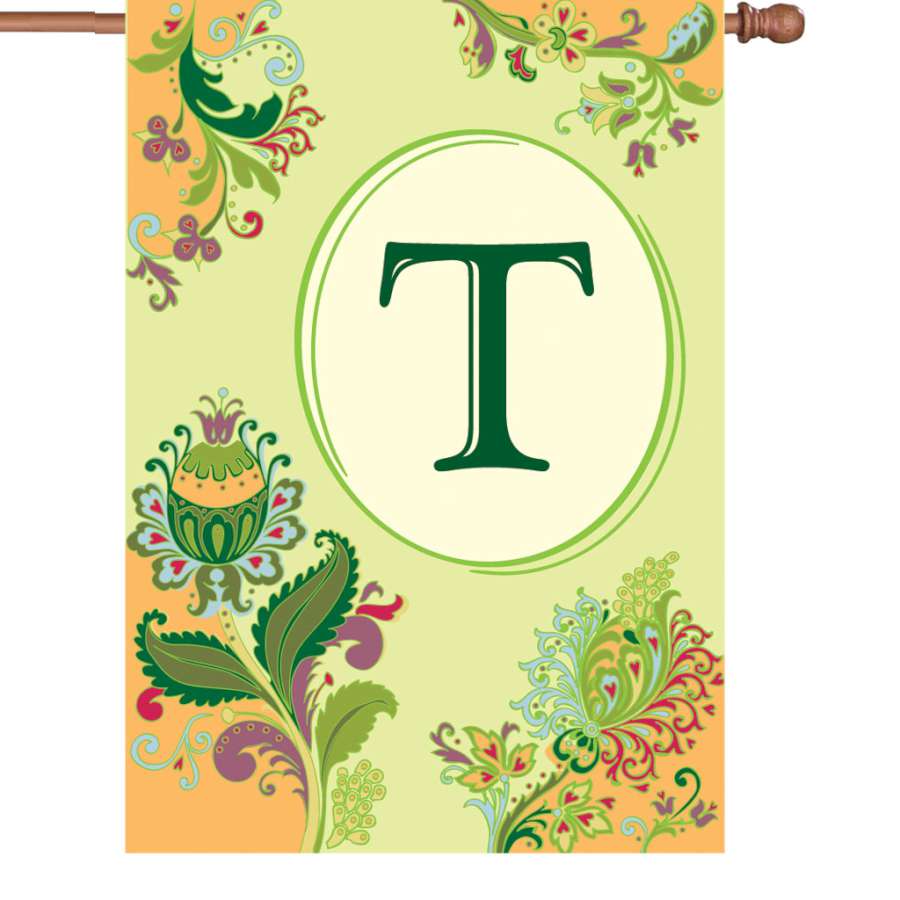 28 in. Spring Monogram Flag - T, featuring an elegant 'T' monogram design, fluttering by a house in vibrant spring colors, enhancing outdoor decor.