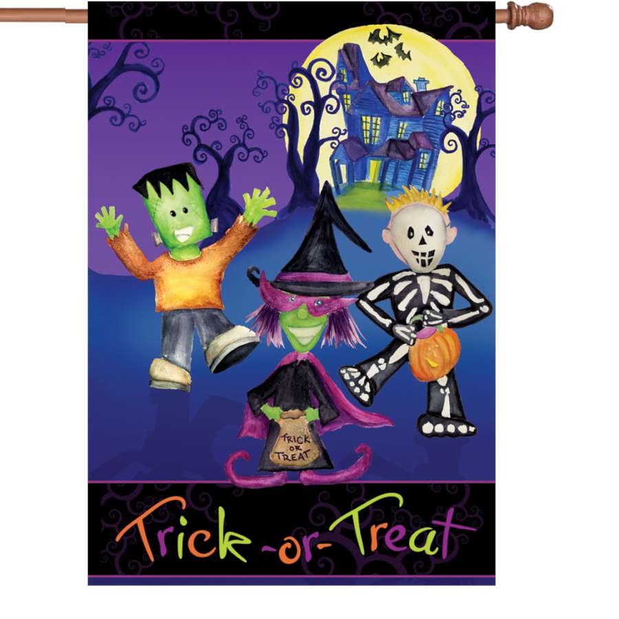 28 in. Trick or Treaters flag made from PremierSoft fabric, featuring colorful Halloween designs displayed on a pole in a yard setting.