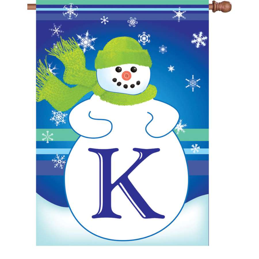 28 in. Winter Monogram Flag - K displaying a personalized 'K' surrounded by a winter snowflake design on a flagpole in a yard.