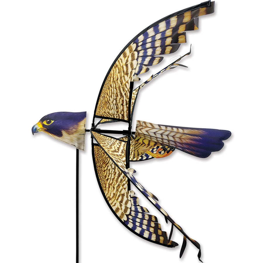 29 in. Peregrine Falcon Spinner in a garden setting, showcasing its detailed design and vibrant colors as it spins gracefully in the wind.