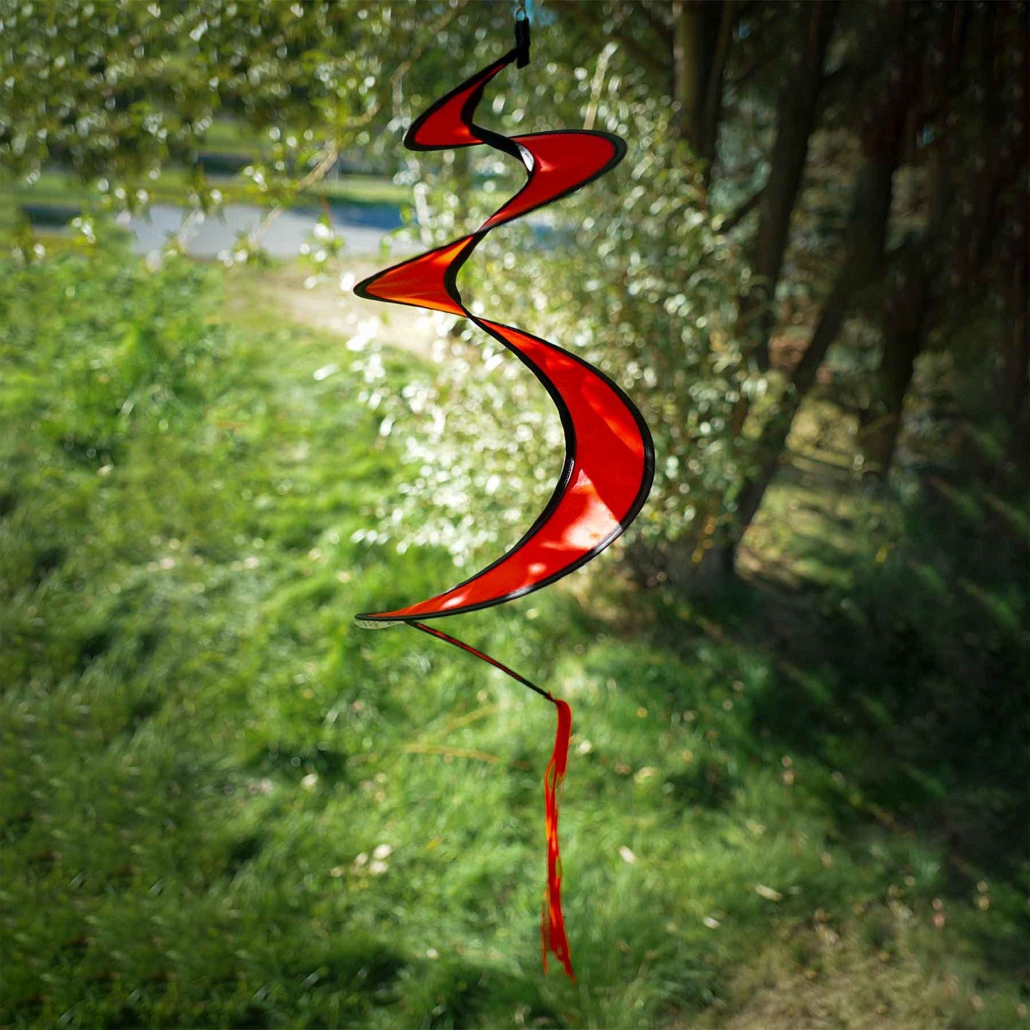 29-inch Red Twister Tail accessory for kites and hot air balloons, elegantly swirling in the outdoor breeze with bright colors.