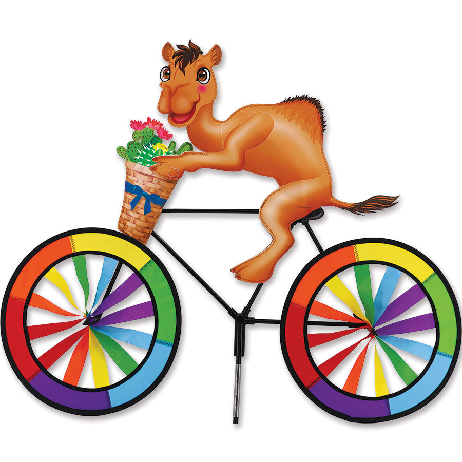 30 in. Bike Spinner - Camel displaying vibrant, colorful fabric panels spinning in an outdoor garden setting.