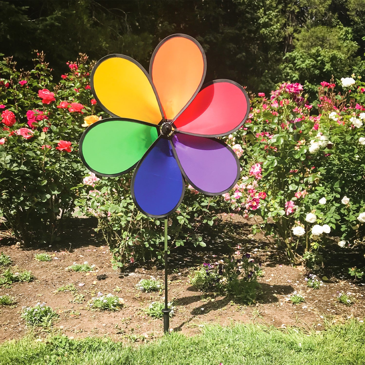 Large 30-inch 6-Petal Rainbow Flower spinner in vibrant colors displayed in a garden setting, spinning gently in the breeze.