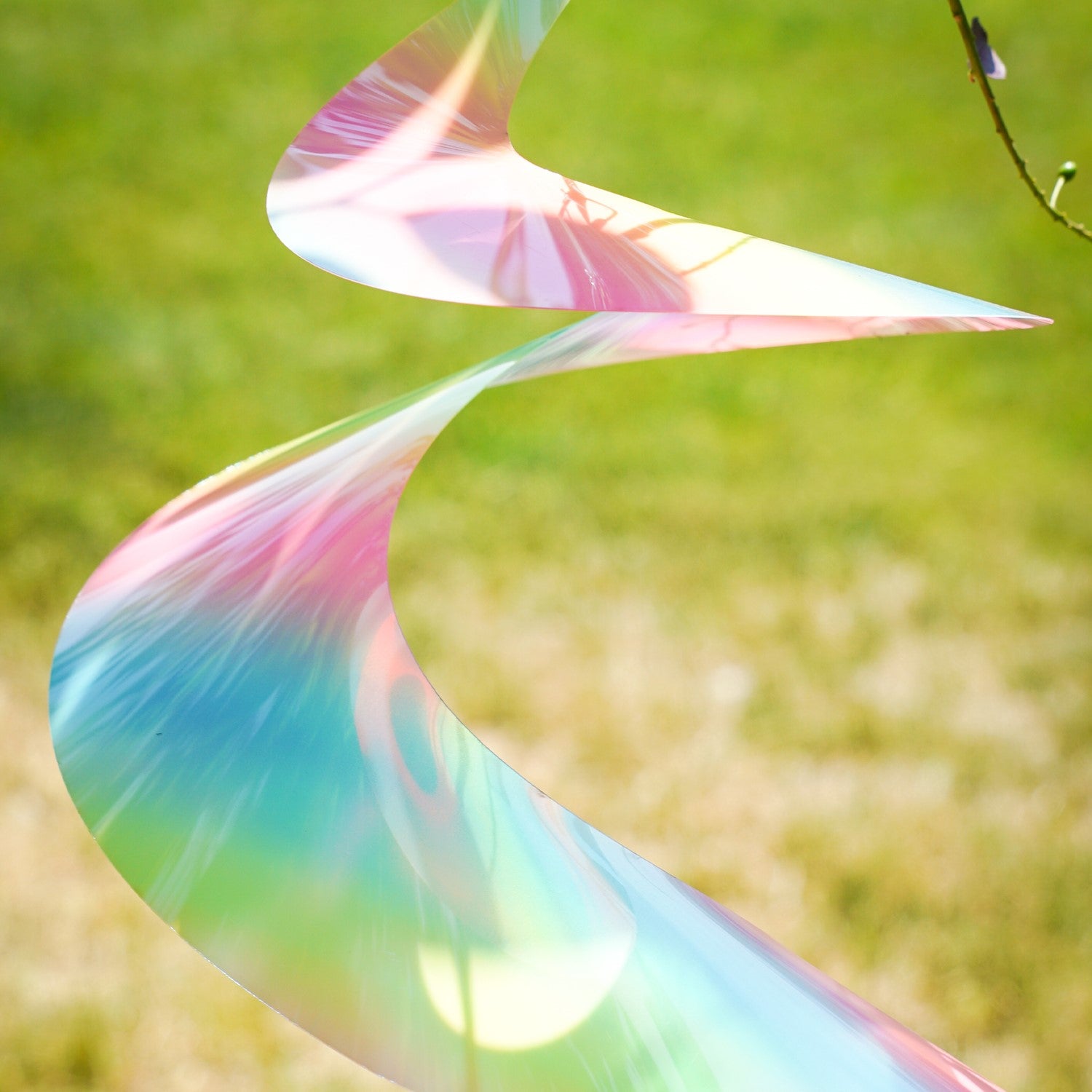 30" Striped Iridescent Twister Tail with vibrant colors and rotational design, gracefully spinning in the breeze and enhancing outdoor aesthetics.