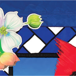 36 in. Elite Oversized Lattice Flag featuring cardinal and dogwood design, displayed on a flag pole in a lively garden setting.