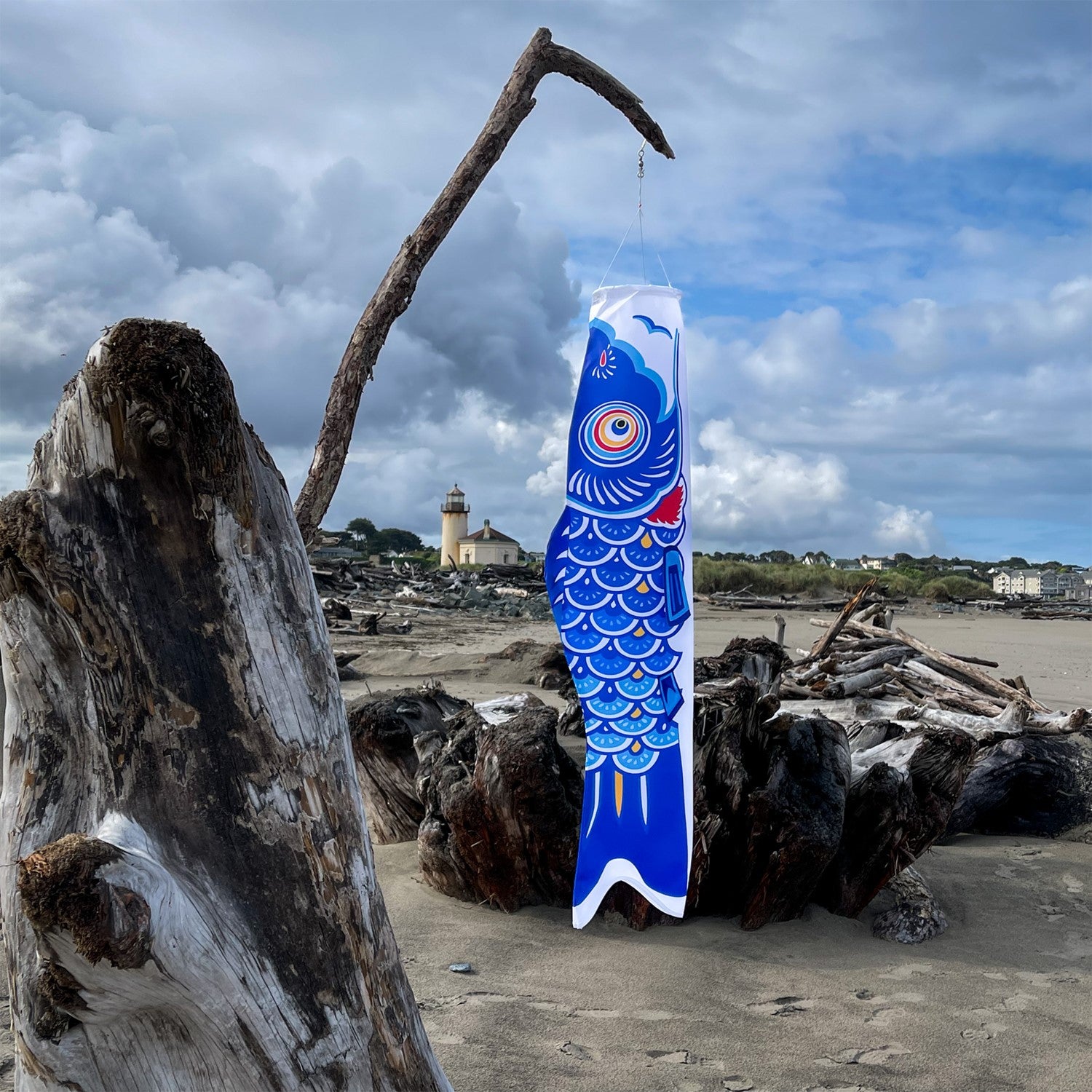 36-inch Blue Koi windsock featuring a colorful Koi fish design hanging gracefully in an outdoor garden setting.