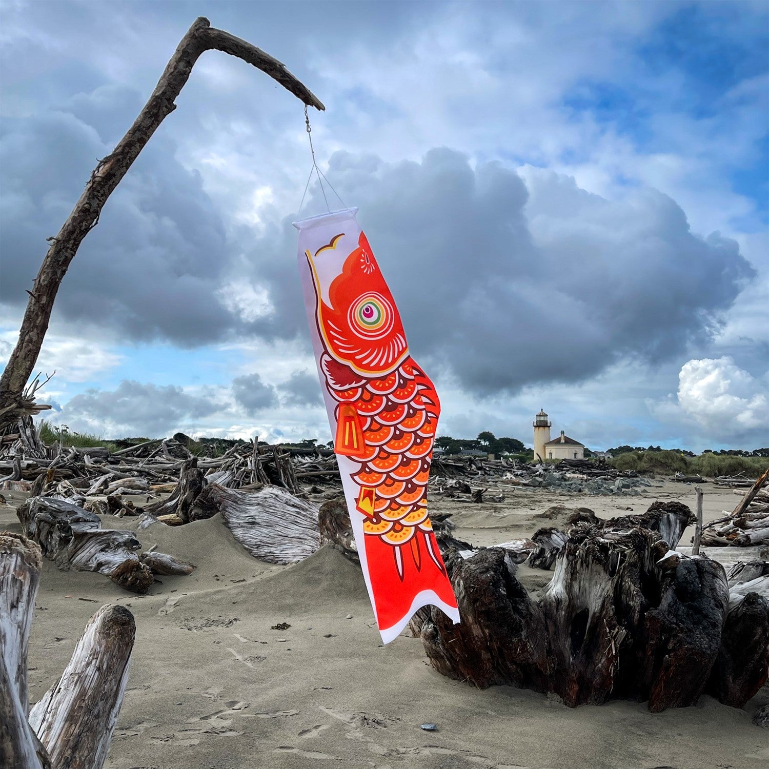 36-inch vibrant Orange Koi windsock, crafted from weather-resistant fabric, elegantly displayed in a garden setting to add color and charm.
