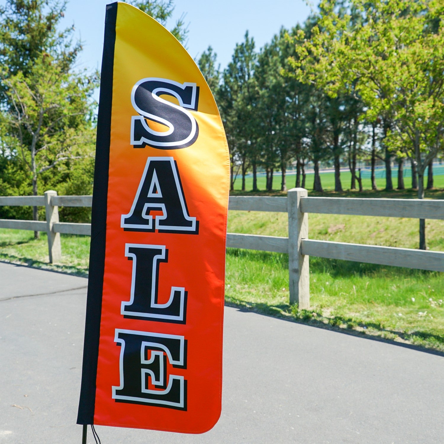 4-foot Heavy Duty Sale Gradient Double-Sided Feather Banner with vibrant rainbow gradient, displayed outdoors at a storefront to attract customers.
