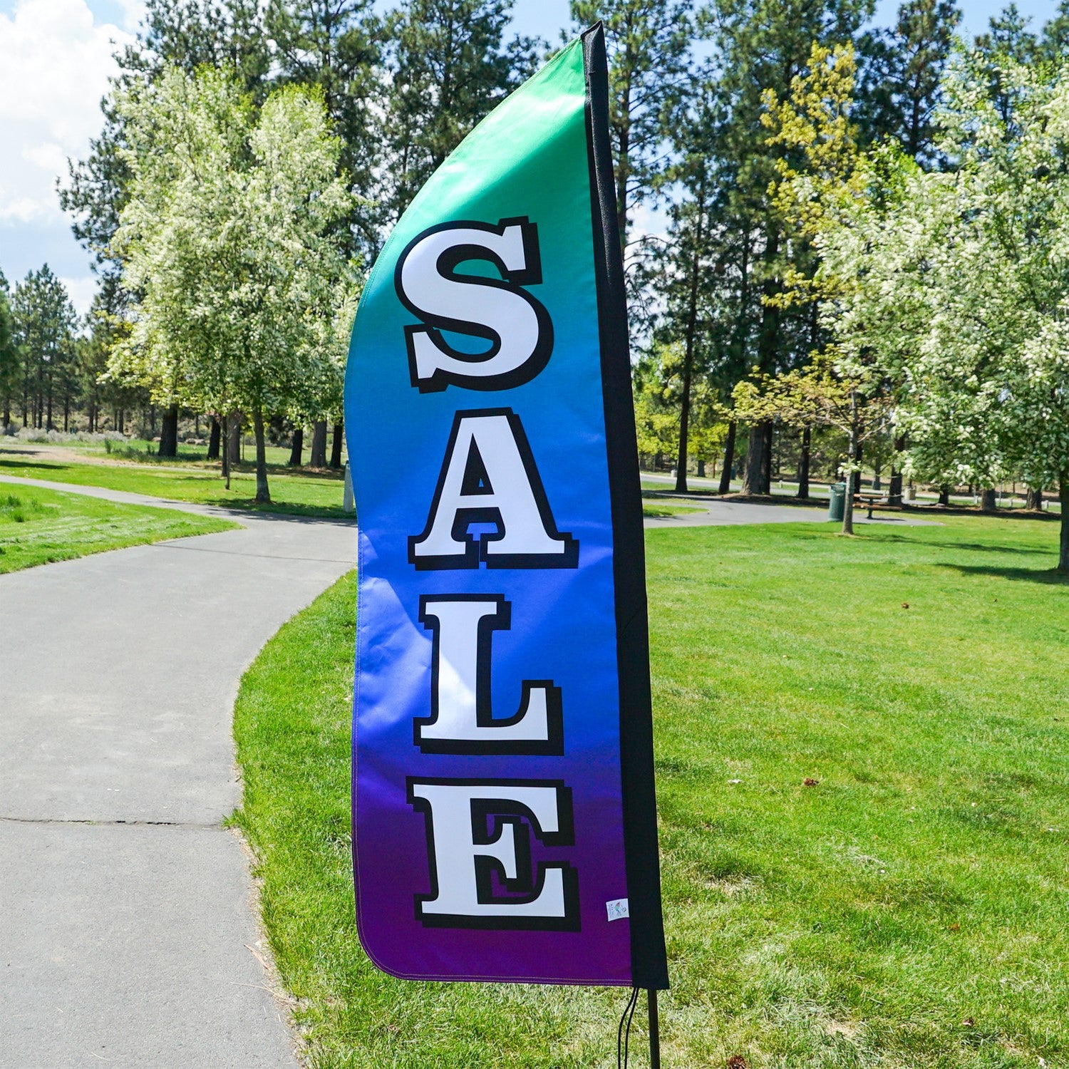 4-foot Heavy Duty Sale Gradient Double-Sided Feather Banner with vibrant rainbow gradient, displayed outdoors at a storefront to attract customers.