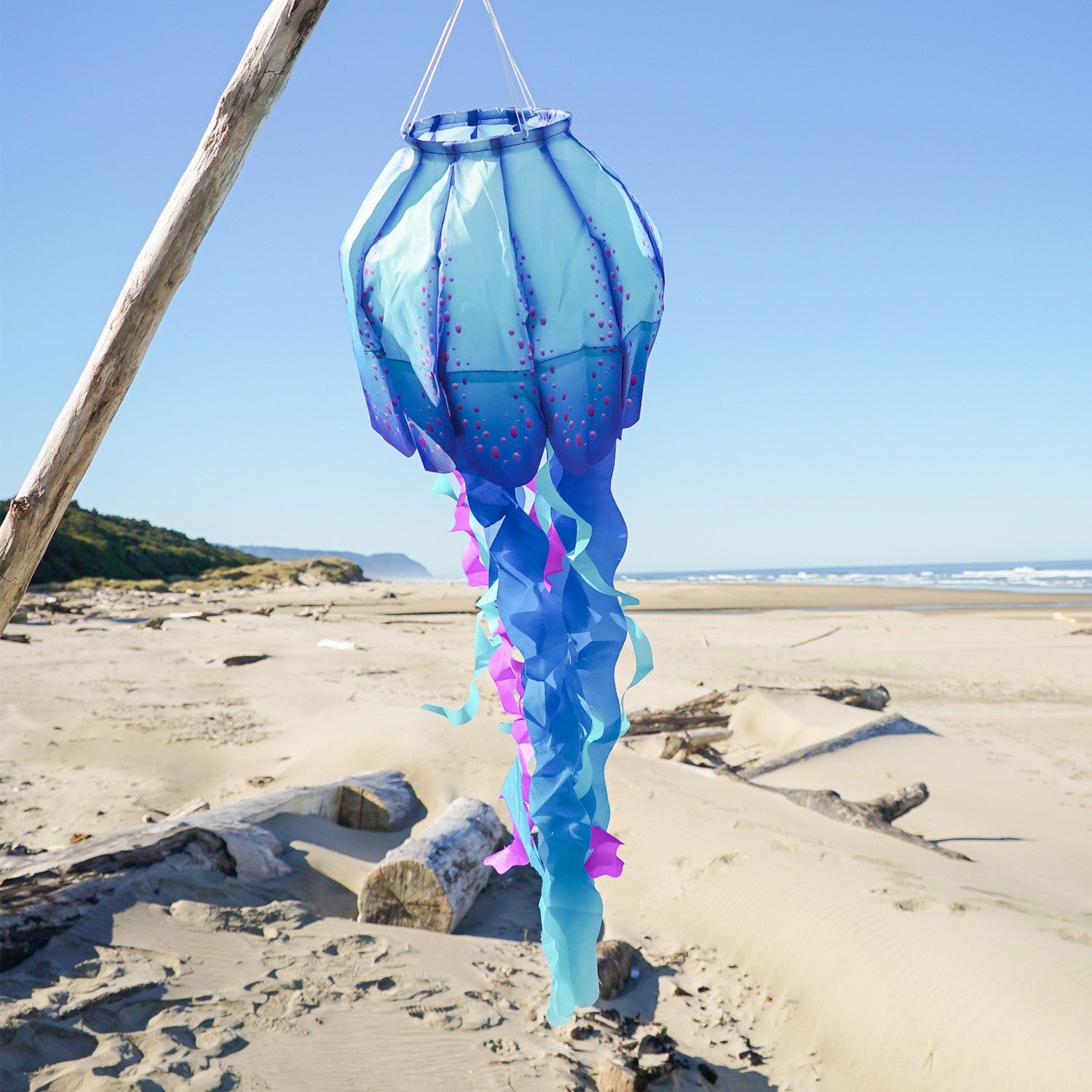 The 40" Blue Jellyfish 3D Windsock features detailed jellyfish design with vibrant colors, dancing in the wind for a whimsical outdoor effect.