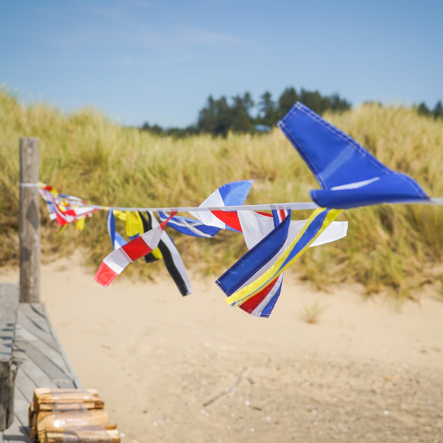 40 Piece Maritime Signal Flags on String decorated across a wooden terrace, featuring various colors and nautical designs that represent maritime communication.