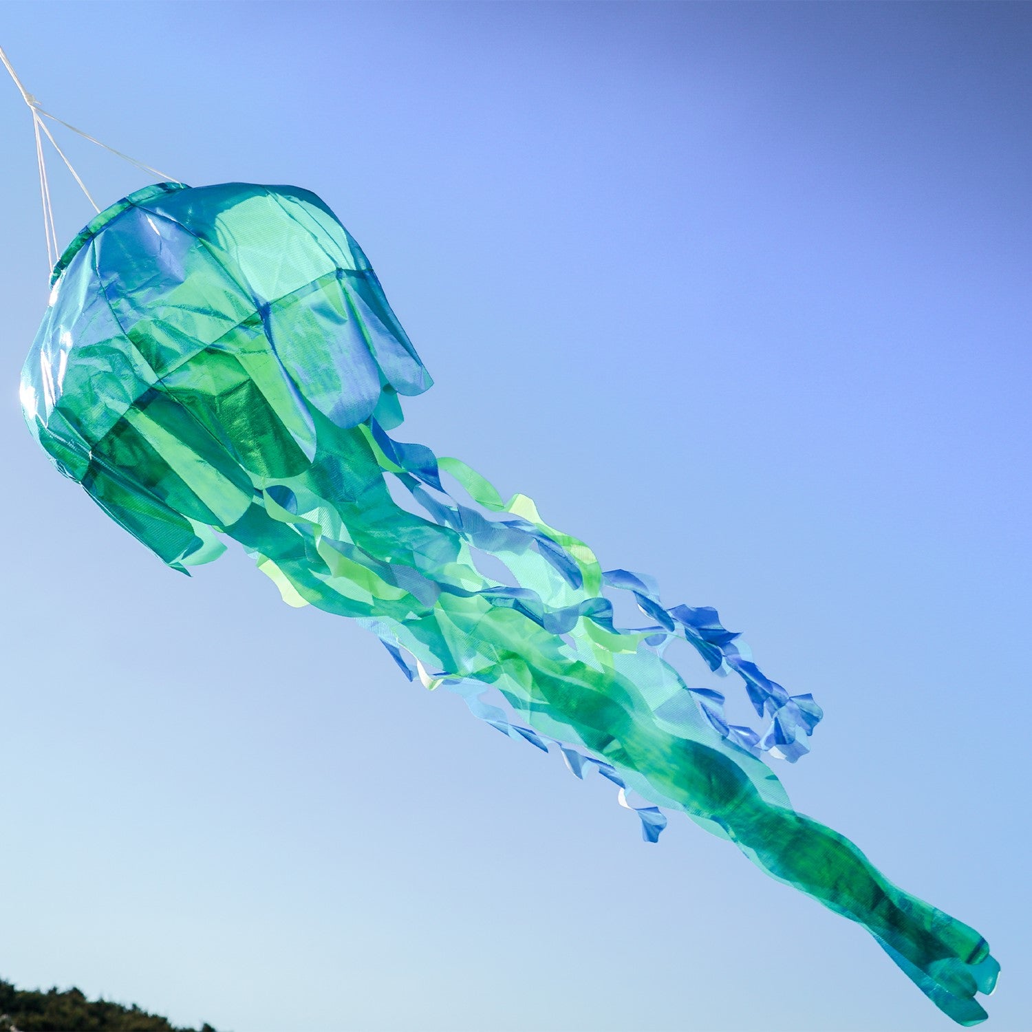 A beautiful 40" Teal Iridescent Jellyfish 3D Windsock with 12 flowing tentacles, designed for outdoor display, showcasing captivating ocean-inspired decor.
