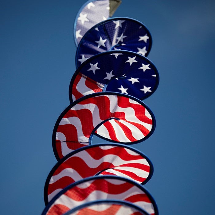 48-inch Stars and Stripes Curlie featuring red, white, and blue graphic dancing in the breeze as a decorative outdoor hanging piece.