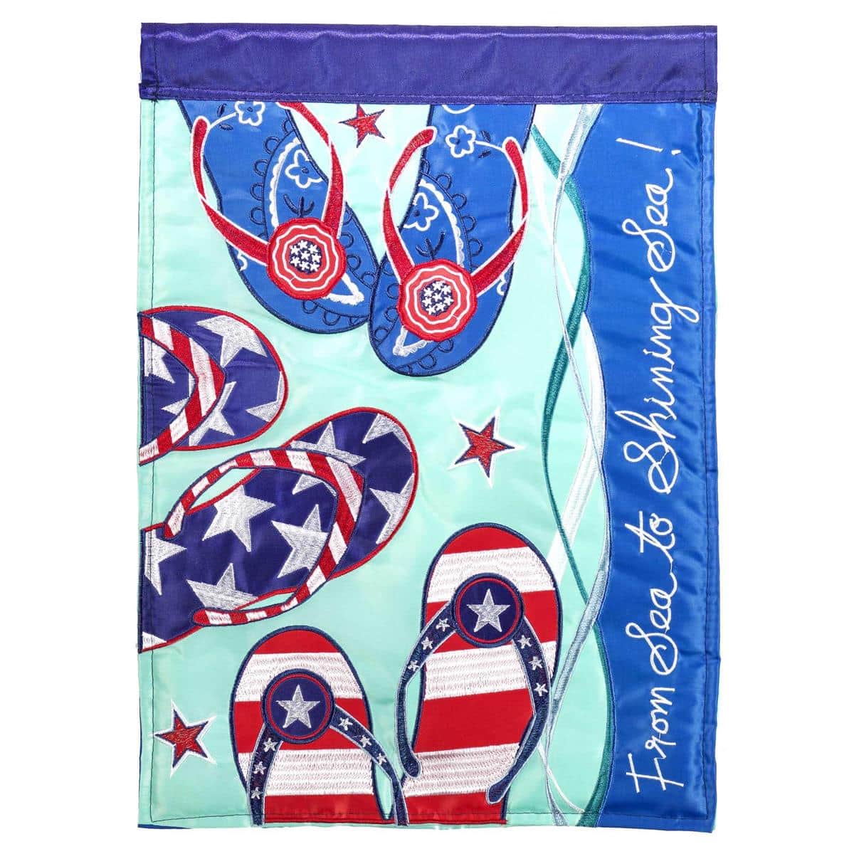 Double applique 4th Flip Flops Garden Flag, 13 x 18 inches, patriotic red white and blue flip flops design, two sided, shown on a garden stand by flowers.