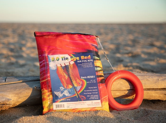 5.0 Tie Dye Red Air Foil Kite soaring in a bright blue sky, showcasing its vibrant colors and aerodynamic structure.