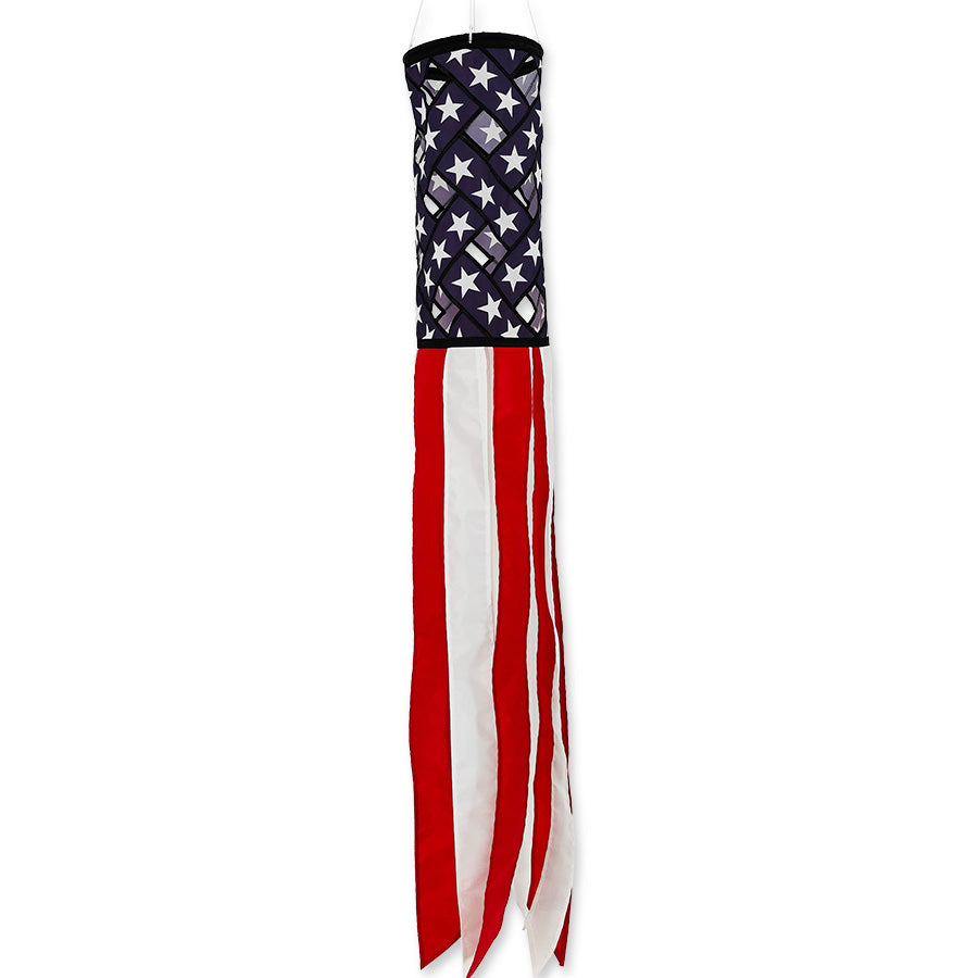 50 in. Lattice Windsock featuring a colorful patriotic design, hanging gracefully from a porch in an outdoor setting.