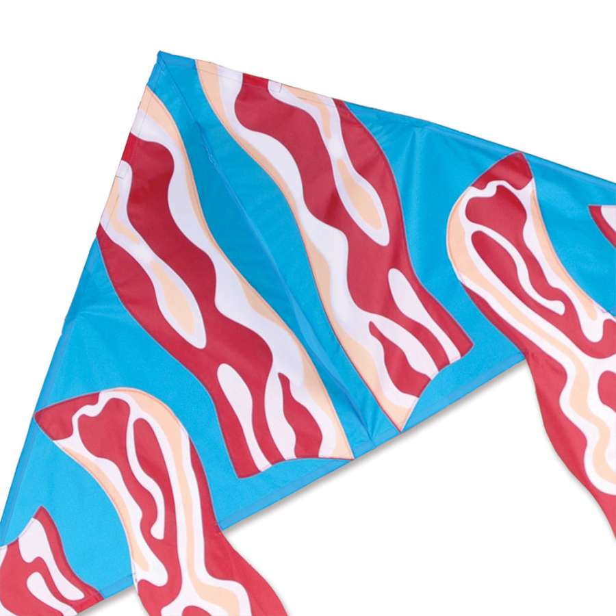 Vibrant 56-inch Delta kite with a bacon design flying in the sky against a clear blue backdrop, showcasing its playful aesthetic.