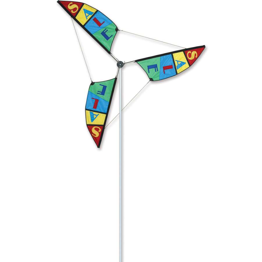 6.5 ft. Wind Generator with colorful blades rotating in the breeze on its 10.5 ft. aluminum mast in a garden setting.