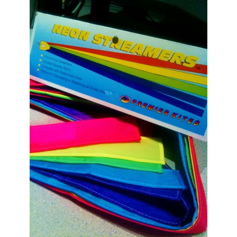 6 ft. 5 Ply Streamers in neon colors attached to a kite, floating gracefully against a bright blue sky during outdoor kite flying.