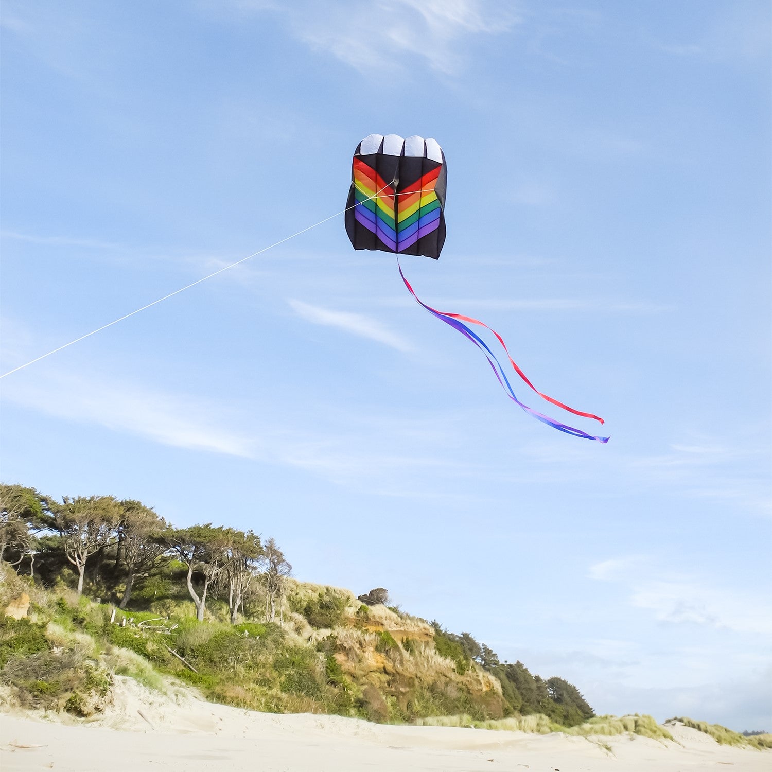 7.5 Rainbow Air Foil kite in flight, showcasing vibrant colors and aerodynamic design against a clear blue sky.