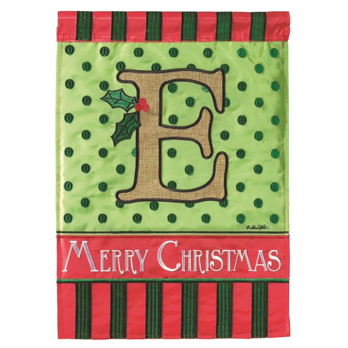 Monogram letter E Christmas burlap garden flag, 13x18 double applique, two sided, hanging on a black stand beside evergreens and holiday lights.