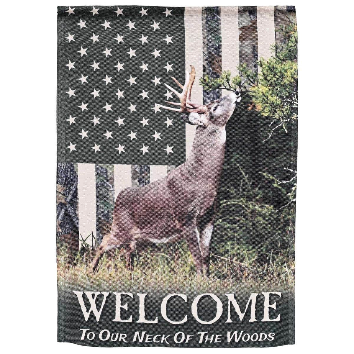 Printed 13x18 Deer Camo Welcome garden flag on stake near porch showing camouflage pattern, deer silhouette, and bold welcome text for rustic outdoor decor