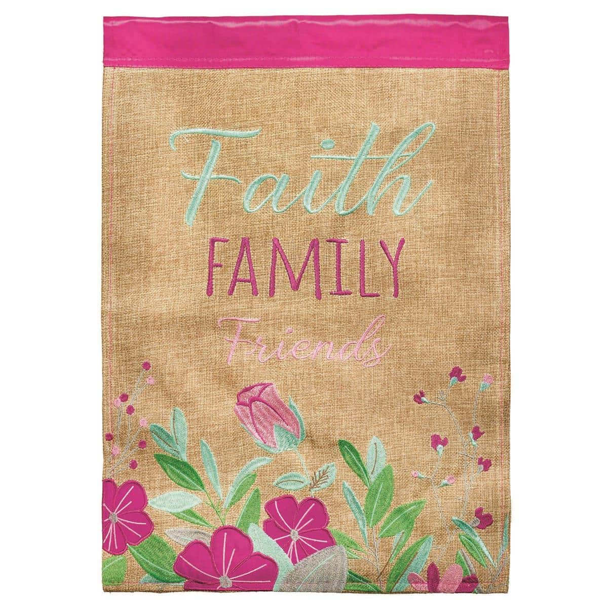 Faith Family Friends 13x18 garden flag with floral double applique, stitched lettering, and vibrant colors displayed on a standard stand in a welcoming front yard