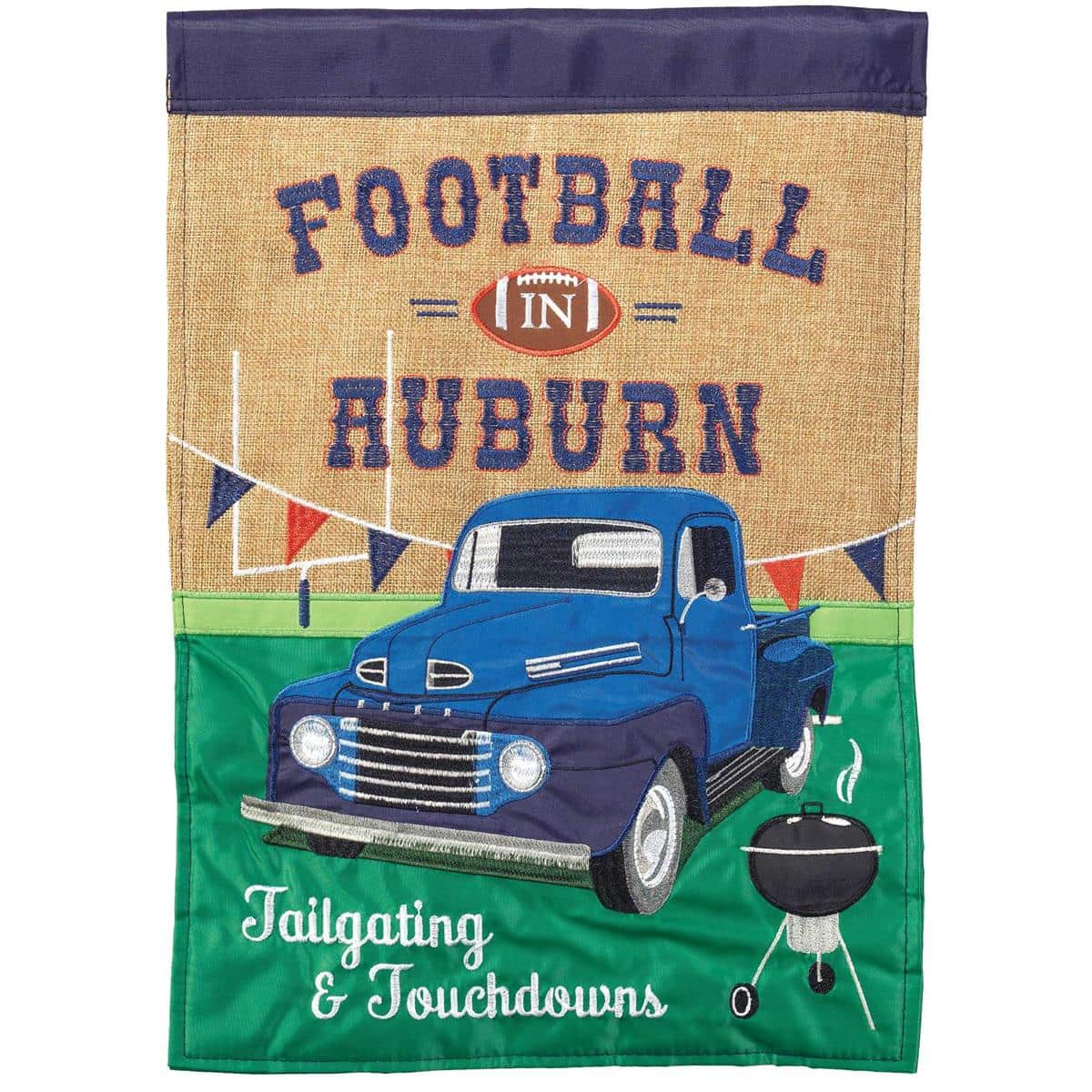 13x18 Auburn navy football garden flag showing bold double applique football graphic, vivid team colors, and reinforced header hanging on a lawn stake by a front porch.